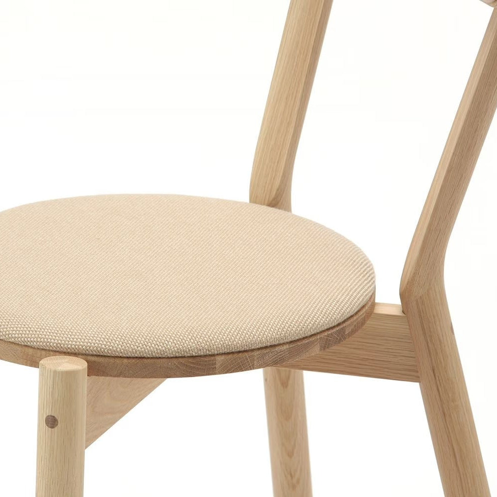 Beige upholstered dining chair with oak frame