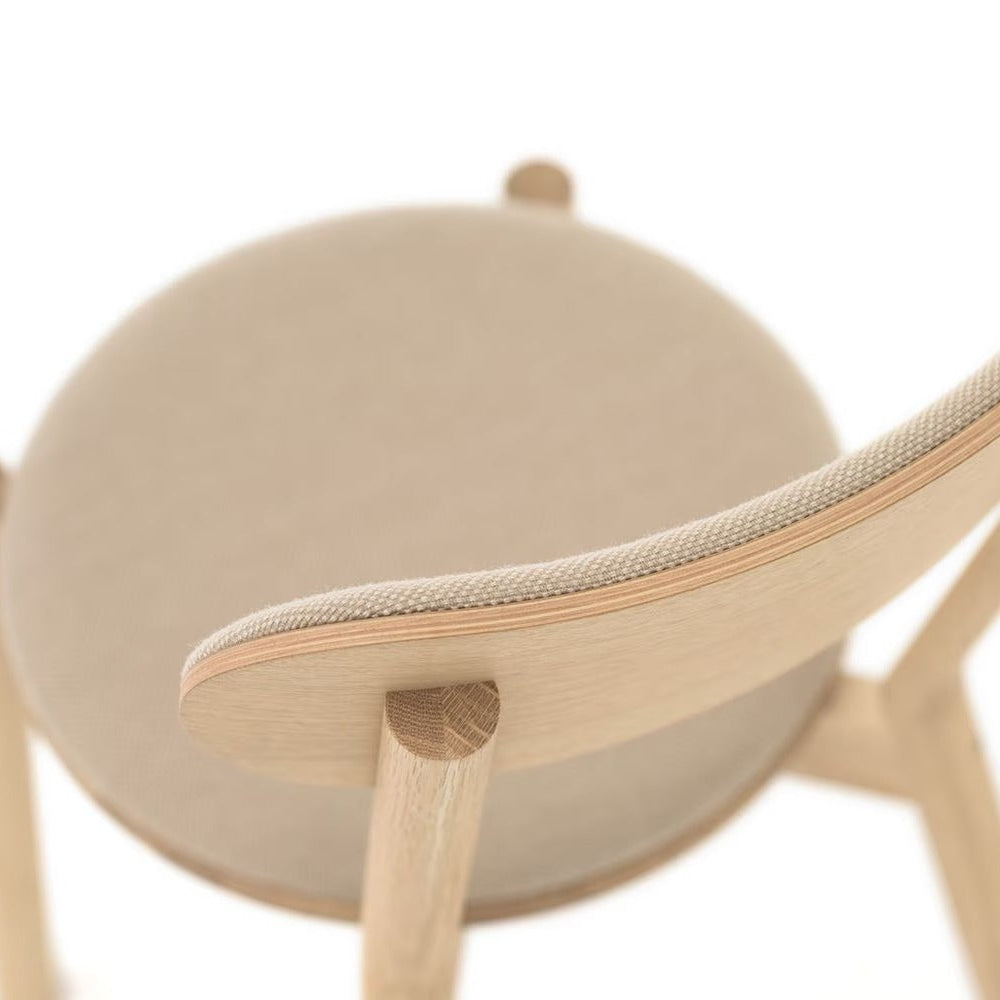 Beige upholstered dining chair with oak frame